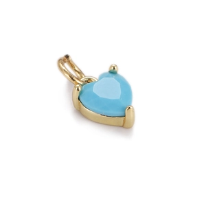 Detail of gold-plated heart pendant with faceted turquoise gemstone on white background