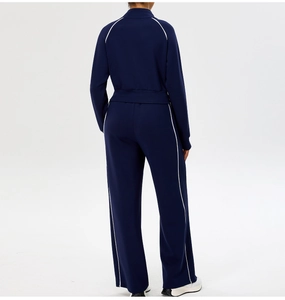 Detail view of navy blue yoga set showing the back cut and white side stripe piping