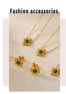 Detail of 18k gold plated sunflower jewelry set with iridescent blue-green gemstones