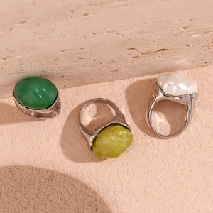 Three retro stainless steel rings with irregular acrylic stones in green and pearl white
