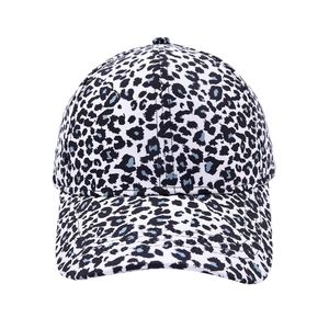 Detailed close-up of a white baseball cap featuring black and blue leopard print patterns
