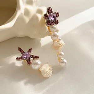 Barrette étoile de mer avec cristal violet et perles nacrées sur base en métal doré