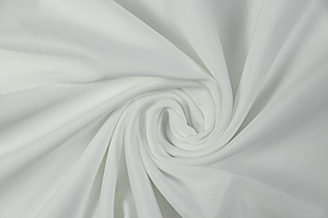 Macro shot of soft white synthetic knit fabric with spiral texture and elegant drape