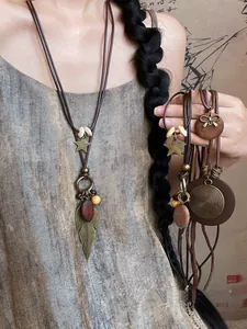 Detail of vintage bohemian star pendants and wooden beads on a long ethnic style necklace