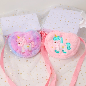 Detail of plush heart-shaped unicorn crossbody bags in pink and purple gradient fur
