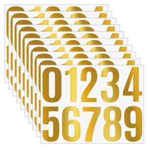Close-up of golden self-adhesive mailbox stickers showing numbers zero to nine
