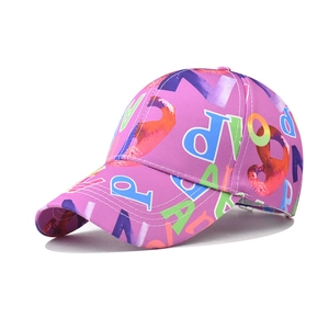 Detail showing colorful graffiti letter printing on a purple cotton baseball cap