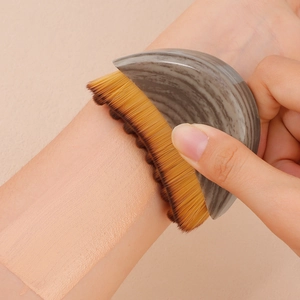 Moon-shaped marble handle foundation brush with soft synthetic bristles for face contouring