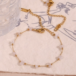 Detail of 18K gold-plated necklace with pink quartz stones and branding tag