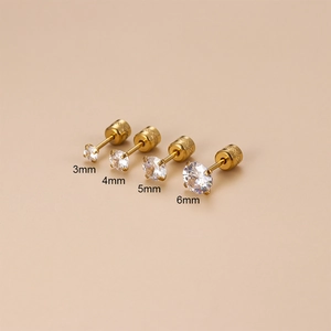 Golden stainless steel stud earrings set with four sizes of round cubic zirconia