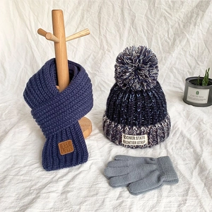 Winter knit set for kids featuring navy scarf, pompom beanie and gray warm gloves