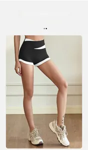 Detail of high-waisted sports shorts with white contrast trim and quick-dry fabric texture
