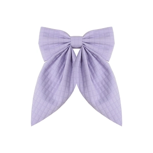 Handmade purple plaid bow hair clip with a long ribbon tail on a plain white background