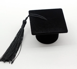 Detail of black velvet graduation cap ring box with a realistic tassel decoration