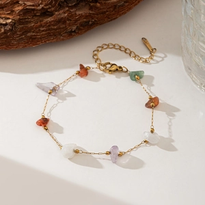 Detailed shot of bohemian beaded necklace with natural stones and gold chain links