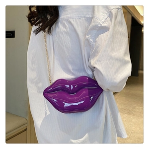 Detailed macro view of the glossy purple lip-shaped acrylic bag with gold metal chain