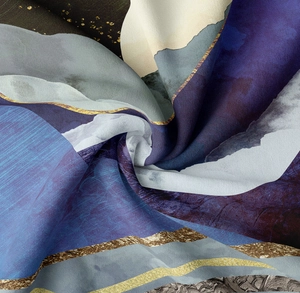 Detail of artistic tapestry with navy blue mountain patterns and golden line accents
