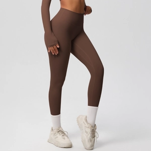 Detail of high waisted dark brown yoga leggings with premium matte seamless fabric
