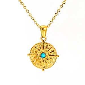 Retro turquoise stainless steel necklace featuring a gold sunburst pendant on white background