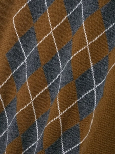 Close-up of classic argyle pattern on brown and grey knit polo sweater fabric