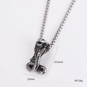 Macro view of silver cobra snake pendant with dimensions 33.5mm by 22mm on box chain