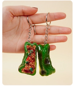 Macro detail of a realistic PVC tiger skin green pepper stuffed with meat keychain