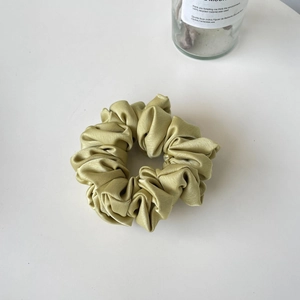 Elegant silk satin scrunchie in light green with pleated ruffles for women hair styling