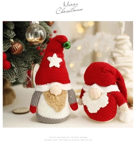 Detail of handcrafted knitted Christmas gnomes with red hats and star decor