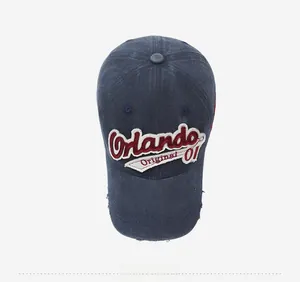 Macro detail of navy washed denim cap with Orlando 3D embroidery and distressed brim
