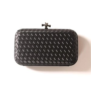 Elegant black woven evening clutch with a distinctive metal knot clasp and leather texture