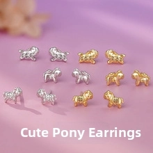 Detailed close-up of cute silver and gold horse stud earrings with textured finish