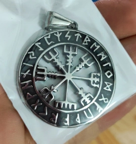 Macro detail of Nordic Viking Vegvisir compass pendant with Elder Futhark rune engraving