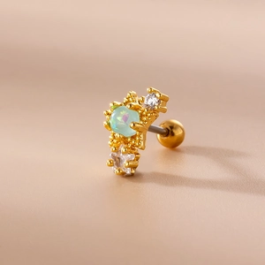 Macro shot of gold stainless steel stud earring with green opal and clear crystals
