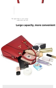 Detail view of red lychee grain handbag showing large capacity for daily essentials