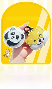 Detailed close-up of handmade leather panda and shiba inu keychains with premium stitching