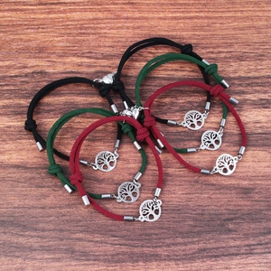 Magnetic Tree of Life couples bracelets with braided rope and heart charms on wood