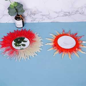 Detail of sunburst resin molds showing orange and red gradient textures and mirror inserts