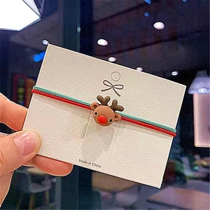 Detail of Christmas reindeer hair tie with red and green elastic bands and 3D charm