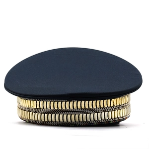 Detail of black military cap with gold metal chains and sparkling colorful rhinestones
