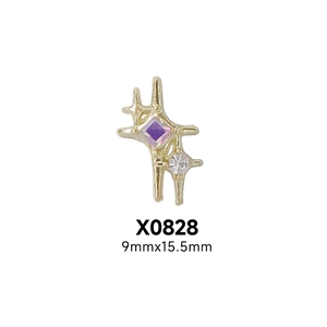 Detail of star-shaped gold alloy nail charm with purple gemstone, size 9mm x 15.5mm