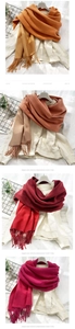 Detail showing various colors of soft cashmere-like scarves with fringe for winter