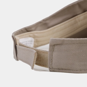 Detail of adjustable Velcro strap and soft sweatband on khaki summer sun visor cap