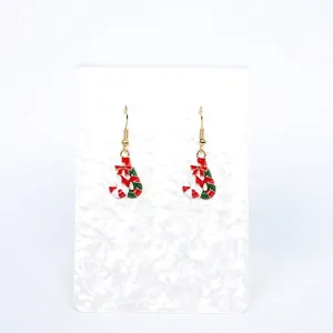Detail of red and green striped Christmas candy cane earrings with festive bow