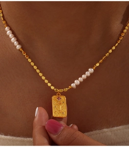 Detailed close-up of vintage gold rose pendant with purple gemstone and pearls