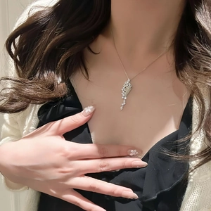 Silver hourglass pendant necklace with shimmering zircons on elegant clavicle chain