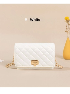 Close-up of white quilted leather bag with golden square metal twist lock and chain strap