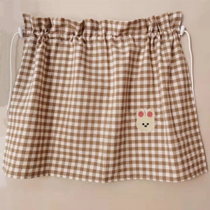 Detail of checkered sunshade curtain with cute rabbit embroidery and ruffled top