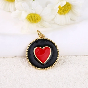 Detailed close-up of 18k gold-plated heart pendant with black and red enamel finish