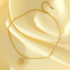 18K gold plated moon and heart pendant necklace with shimmering crystals on silk background