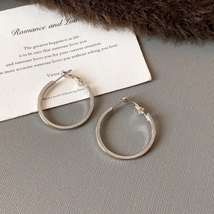 Sleek silver minimalist geometric hoop earrings with textured fold design for women